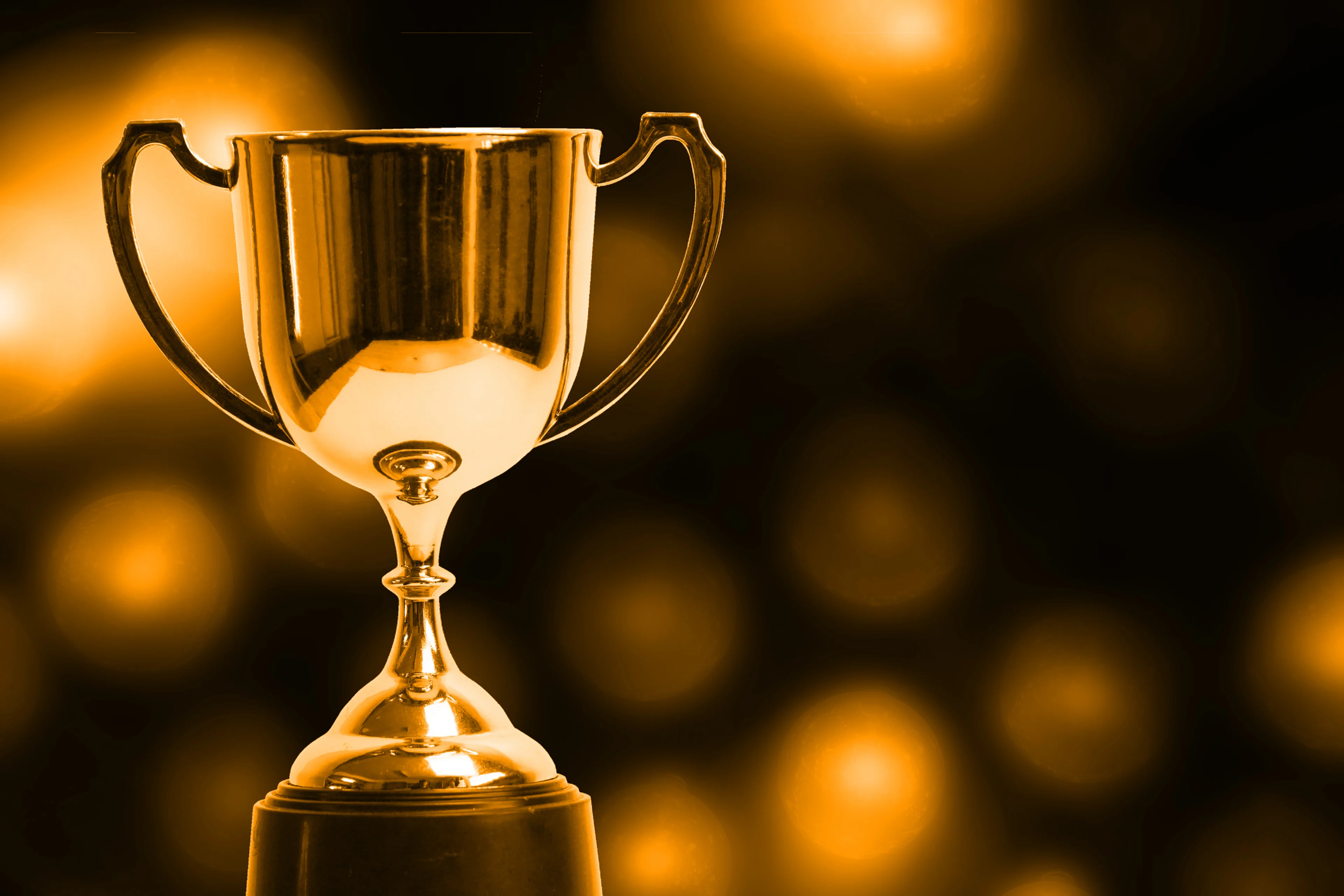 Gold background with a gold trophy being the focal point.