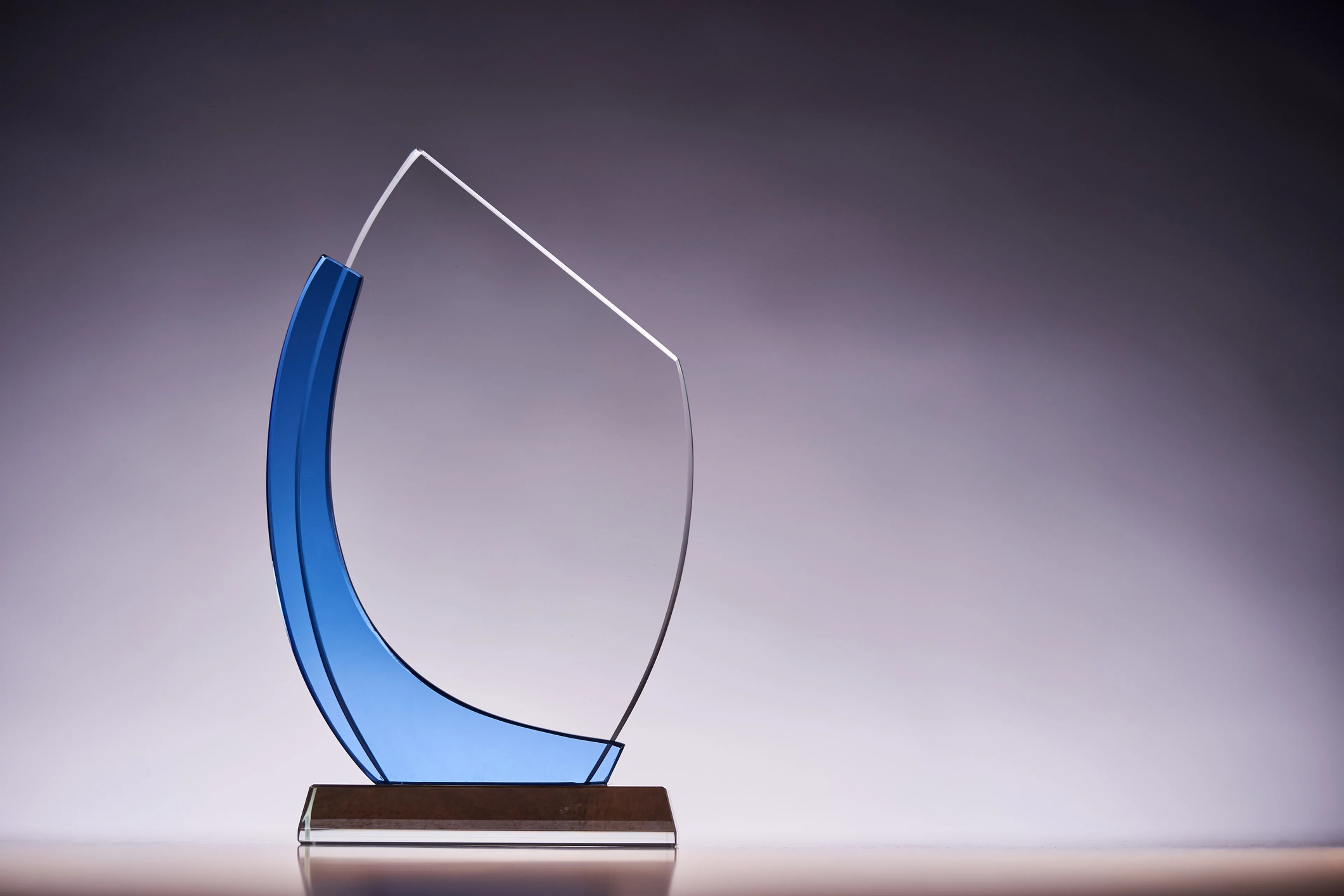 Crystal trophy with a dark background.