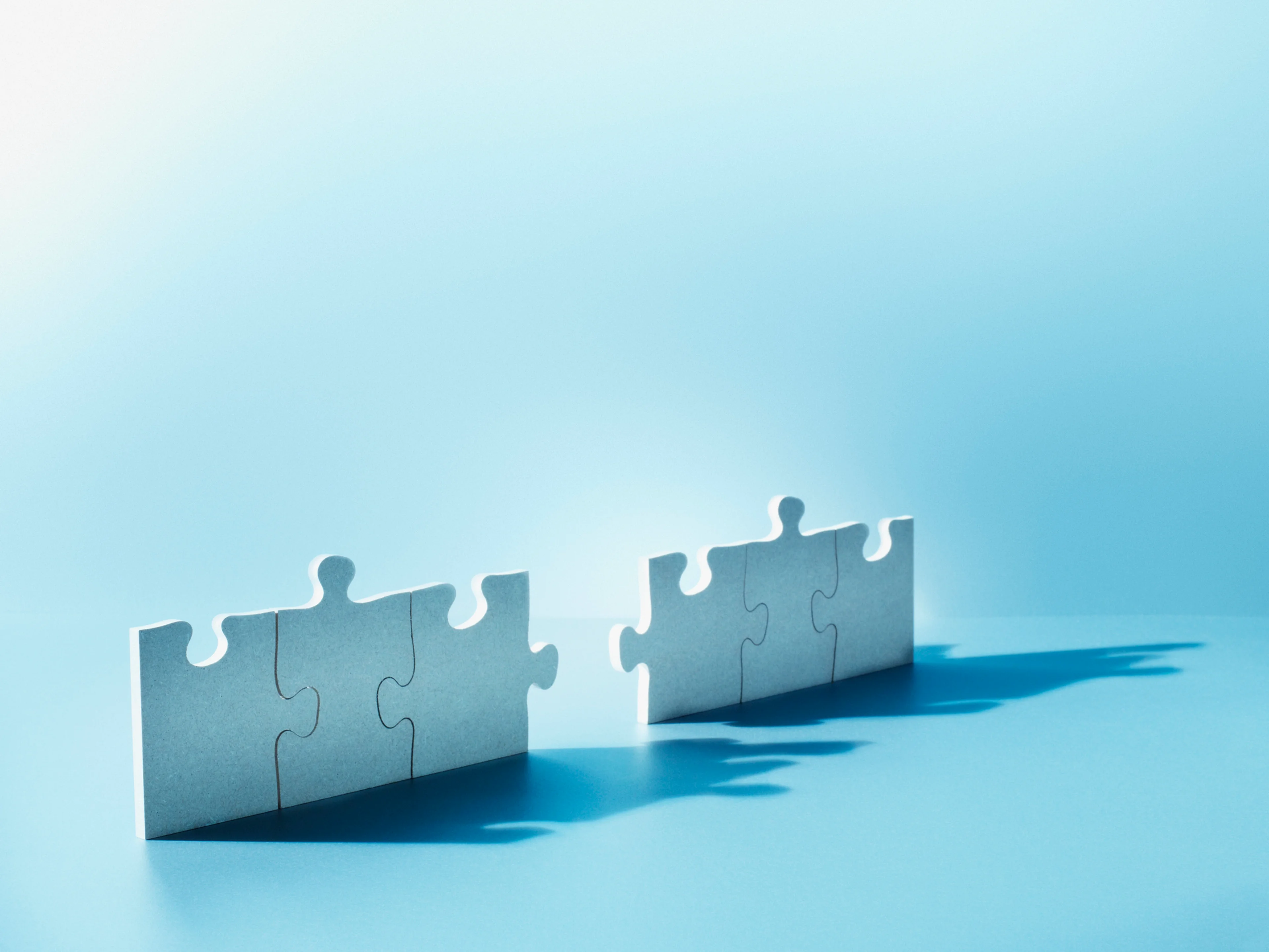 Puzzle pieces standing with one missing to complete it.