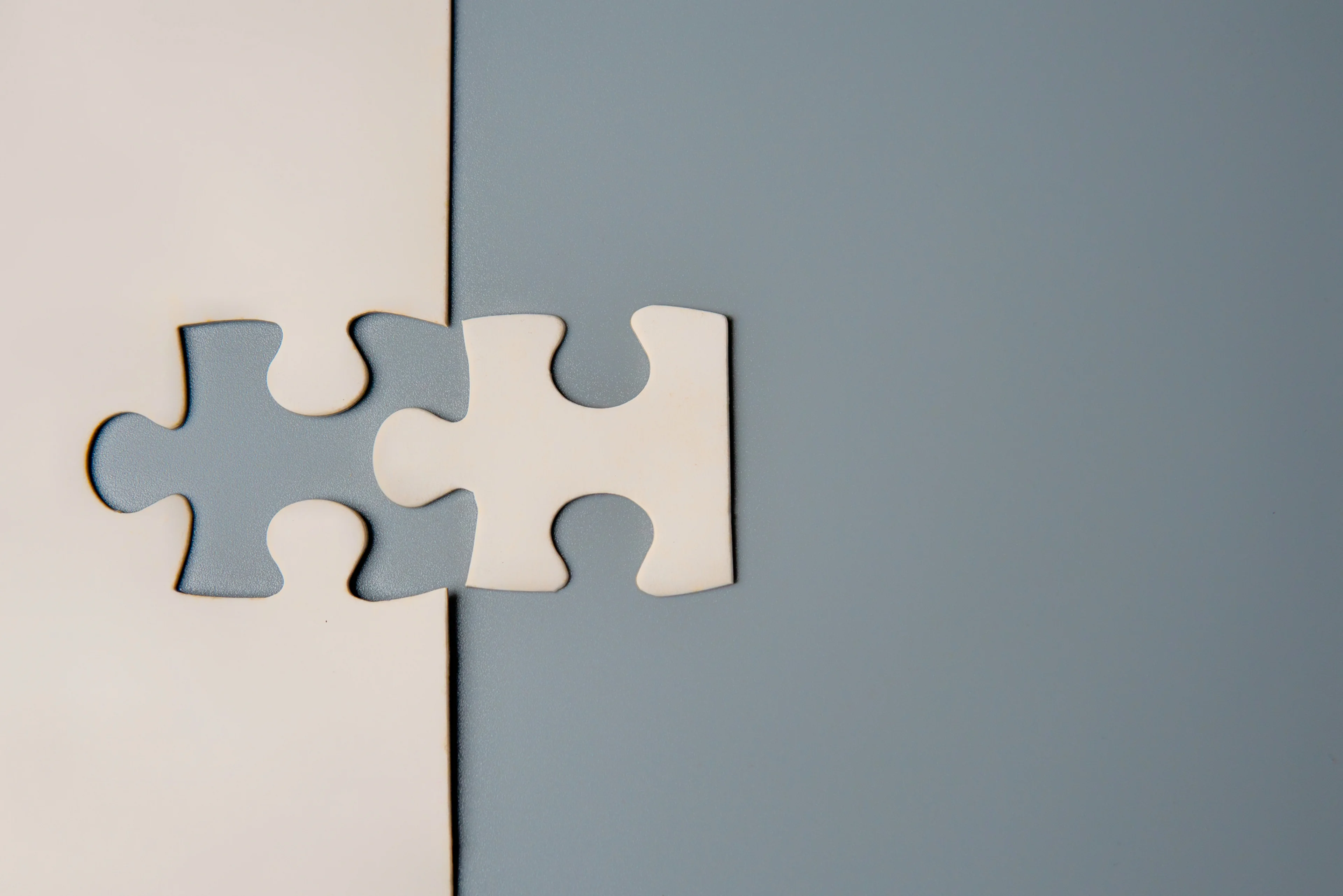 Grey background and a white puzzle piece.