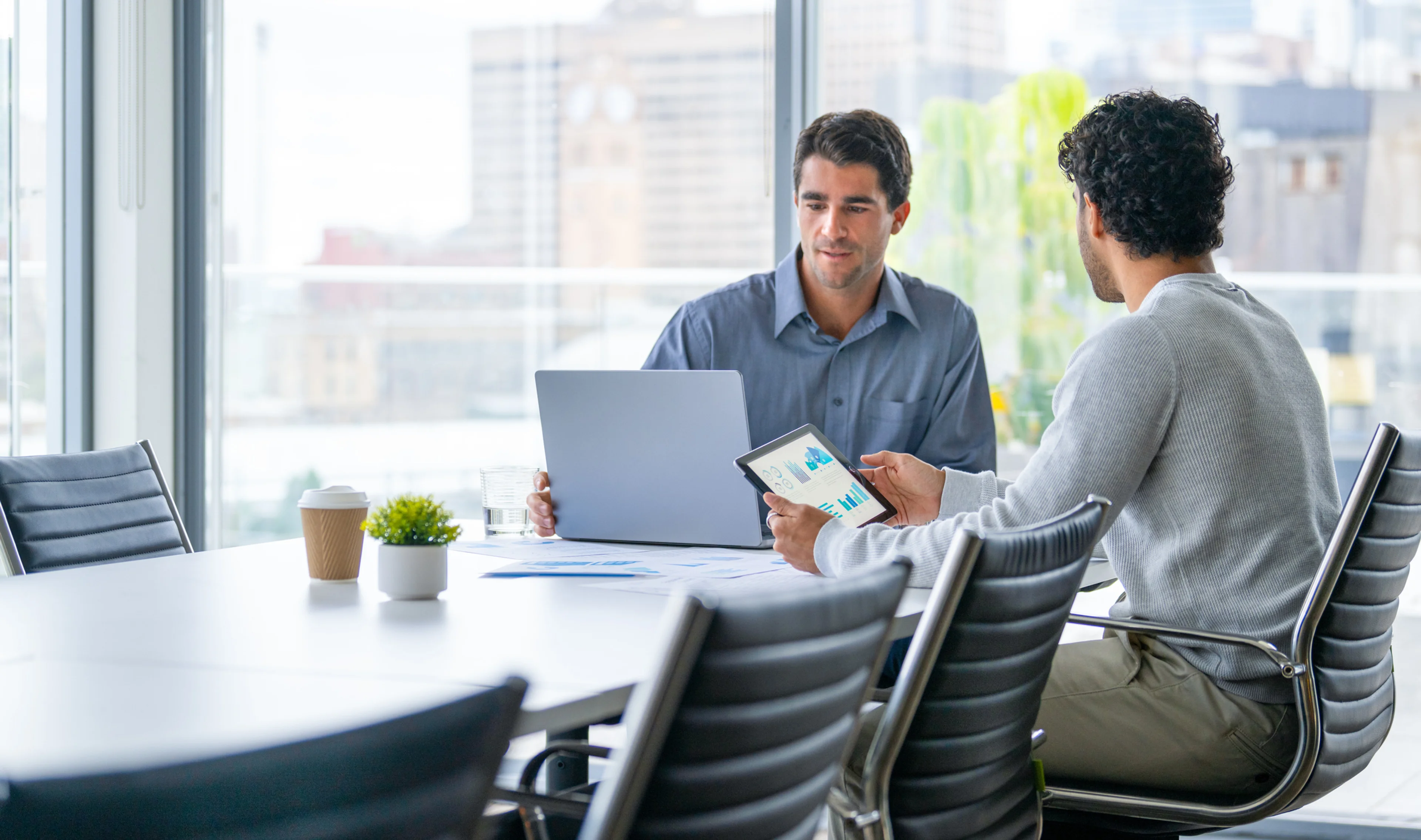 businessmen reviewing reports in meeting